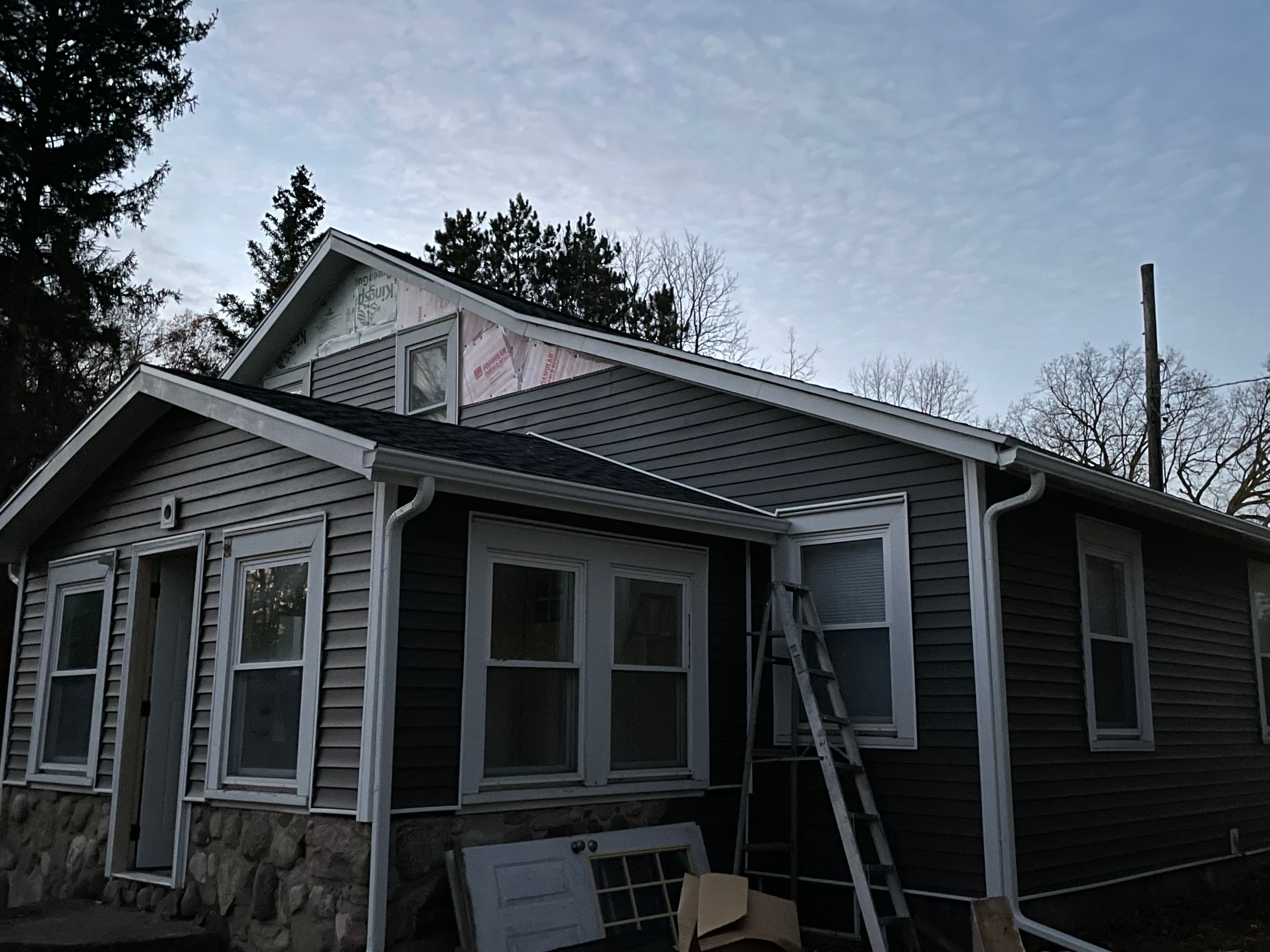 Full exterior restoration with siding and gutters